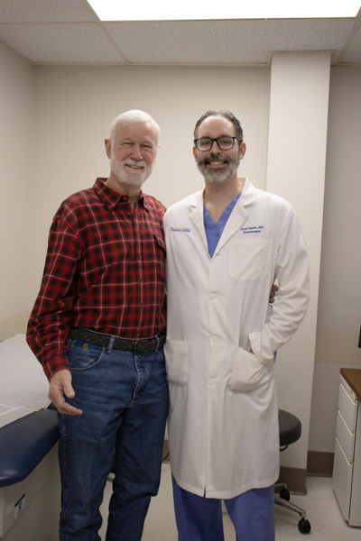 Raymond Sinele with Dr. Andrew Smith in clinic after his spinal surgery.